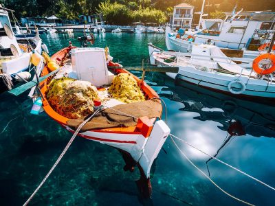 colorful-greek-fishing-boats-in-small-port-harbor-resize.jpg